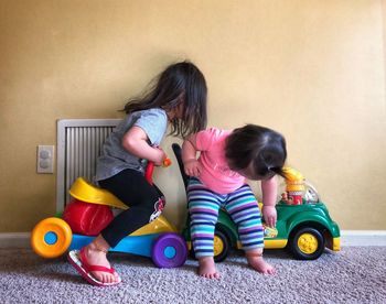 Siblings playing with toy