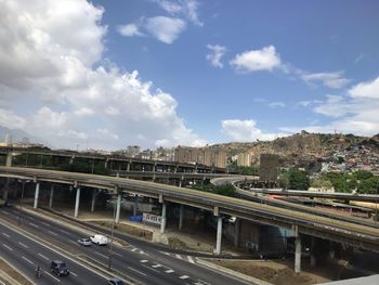 High angle view of train on highway in city against sky