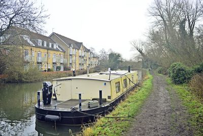 View of canal by building against sky