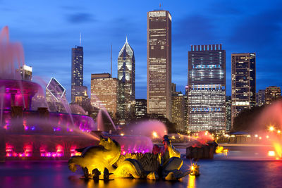 Digital composite image of illuminated buildings in city at night