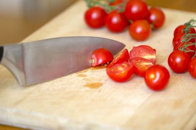 Close-up of knife and tomatoes on cutting board