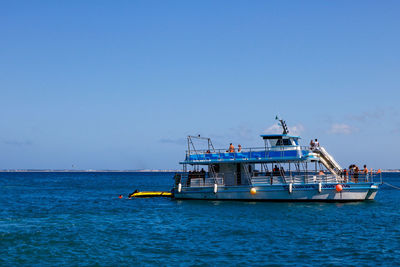 Boat on sea against blue sky