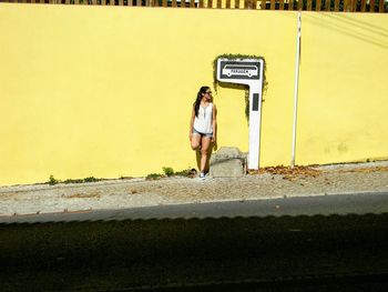 Full length of woman standing on road