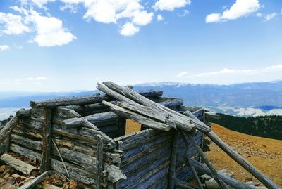 Wooden structure on mountain against sky