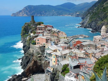 High angle view of townscape by sea against sky
