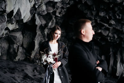 Portrait of young couple standing outdoors