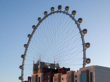 Low angle view of ferris wheel against sky