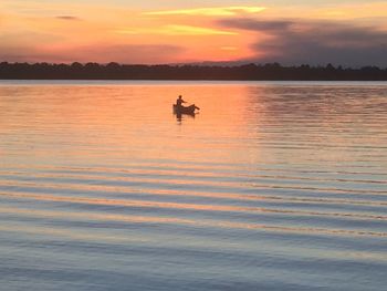 Scenic view of lake at sunset