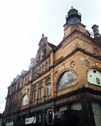 Low angle view of clock tower against sky