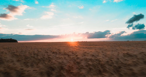 Scenic view of beach against sky during sunset