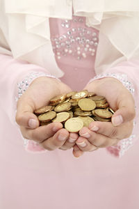 Midsection of woman holding coins