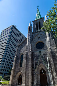 Low angle view of buildings against sky in city