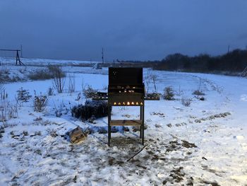 Built structure on snow covered field against sky