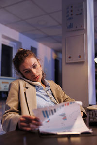 Portrait of young businesswoman working at desk in office