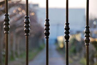 Close-up of metal fence against sky