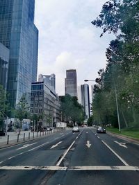 City street and buildings against sky