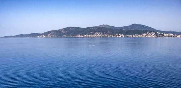 Scenic view of sea against clear blue sky