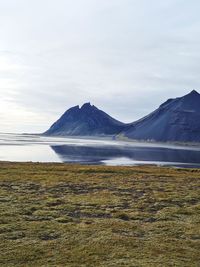 Scenic view of lake and mountains against sky