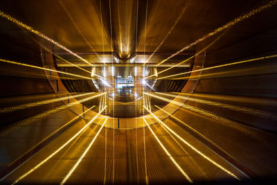 Low angle view of illuminated tunnel