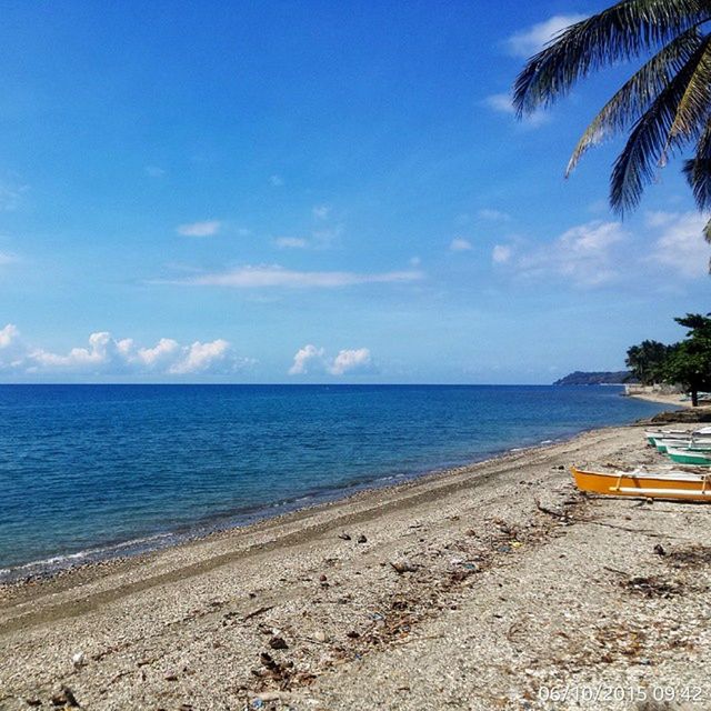 sea, water, beach, horizon over water, sky, shore, tranquil scene, tranquility, sand, scenics, transportation, blue, beauty in nature, nature, tree, palm tree, coastline, cloud, cloud - sky, nautical vessel