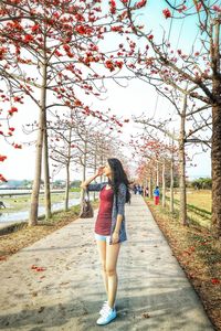 Full length of woman on footpath against sky