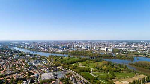 High angle view of buildings against clear blue sky