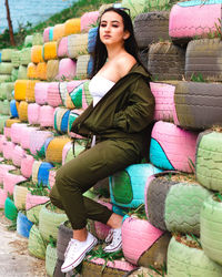 Beautiful young woman sitting outdoors