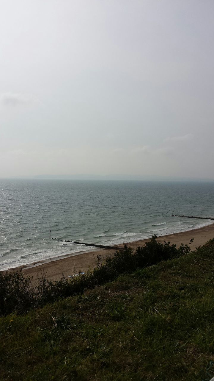 sea, horizon over water, water, beach, tranquil scene, sky, tranquility, scenics, shore, beauty in nature, nature, grass, idyllic, sand, coastline, remote, outdoors, cloud - sky, day, calm