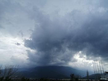 Low angle view of storm clouds over landscape