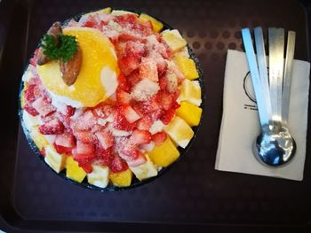 High angle view of candies in plate on table