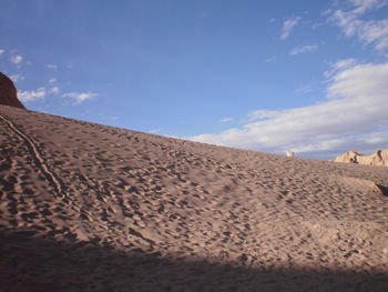 Sandy beach against blue sky