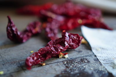 Close-up of red chili peppers on table