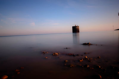 Scenic view of calm sea against clear sky