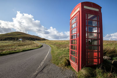 View of road passing through landscape against sky