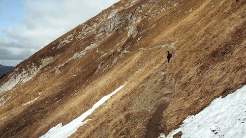 Woman standing on mountain ridge