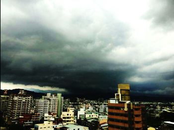 Buildings against cloudy sky