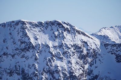 Scenic view of snowcapped mountains against clear sky