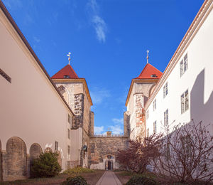 Low angle view of buildings against blue sky