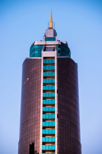 Low angle view of modern building against blue sky