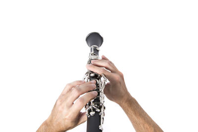 Close-up of man holding hands over white background