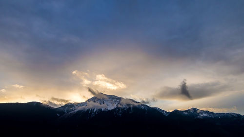 Scenic view of snowcapped mountains against sky during sunset