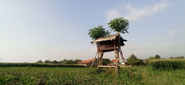 Traditional windmill on field against sky