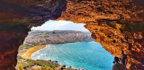 Scenic view of sea seen through cave