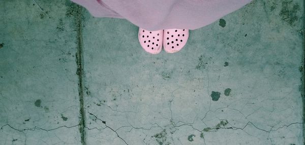 Low section of woman standing on wall