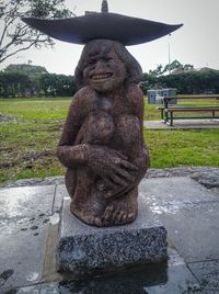 Statue in park against sky