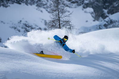 Man skiing in deep powder snow, zauchensee, salzburg, austria