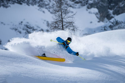 Man skiing on snow covered field