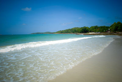 Scenic view of beach against blue sky