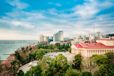 High angle view of buildings against cloudy sky