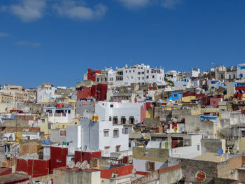 Buildings in city against blue sky